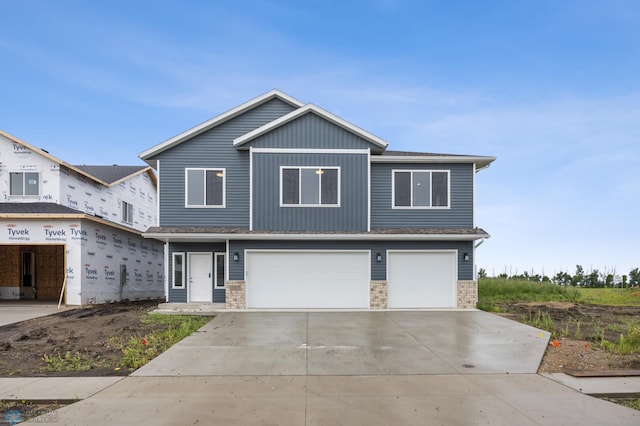 1057 61st Ave W, West Fargo, ND 58078 - view of front of property with a garage, concrete driveway, and brick siding