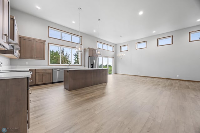 1057 61st Ave W, West Fargo, ND 58078 - kitchen featuring appliances with stainless steel finishes, open floor plan, a kitchen island, plenty of natural light, and recessed lighting