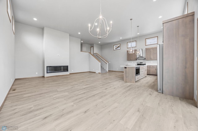 1057 61st Ave W, West Fargo, ND 58078 - kitchen with open floor plan, recessed lighting, light countertops, light wood-type flooring, and a kitchen island