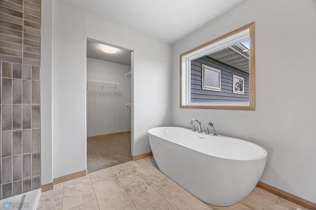 1057 61st Ave W, West Fargo, ND 58078 - full bathroom featuring a spacious closet and a freestanding bath