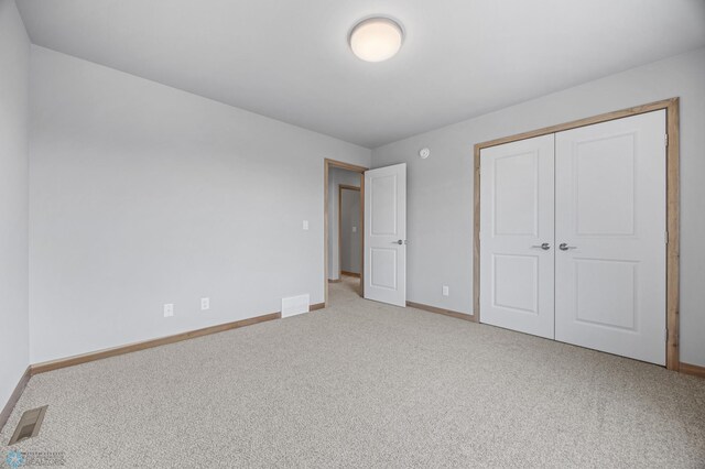 1057 61st Ave W, West Fargo, ND 58078 - unfurnished bedroom featuring carpet and a closet
