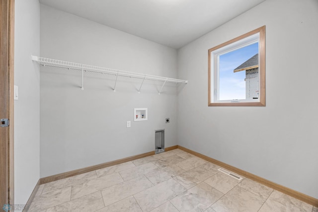 1057 61st Ave W, West Fargo, ND 58078 - laundry area with hookup for an electric dryer, hookup for a washing machine, and light marble finish floors