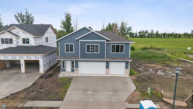 1057 61st Ave W, West Fargo, ND 58078 - view of front of house featuring driveway, a garage, and stone siding