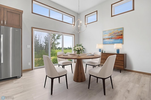 1057 61st Ave W, West Fargo, ND 58078 - dining room with a high ceiling, a chandelier, and light wood-type flooring
