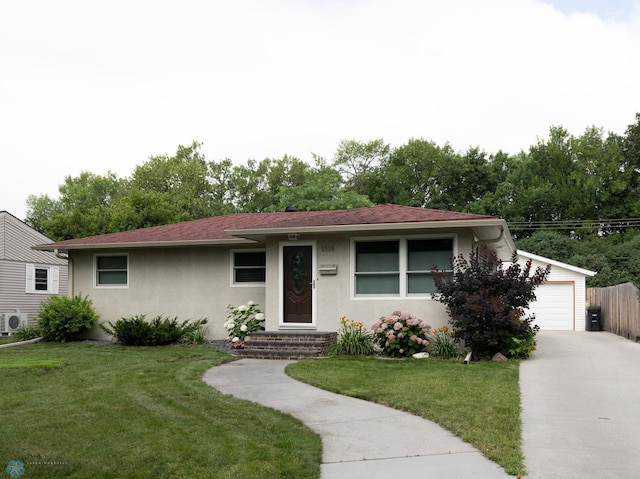 2510 10th St N, Fargo, ND 58102 - ranch-style house featuring stucco siding, concrete driveway, and a garage