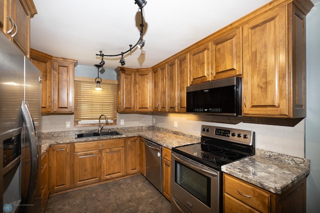 2510 10th St N, Fargo, ND 58102 - kitchen with appliances with stainless steel finishes, brown cabinetry, backsplash, and stone countertops