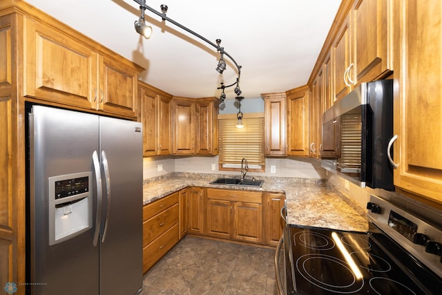 2510 10th St N, Fargo, ND 58102 - kitchen with appliances with stainless steel finishes, brown cabinets, and light stone countertops