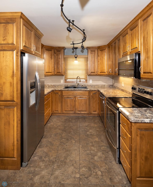 2510 10th St N, Fargo, ND 58102 - kitchen featuring stainless steel appliances, brown cabinetry, and light stone counters