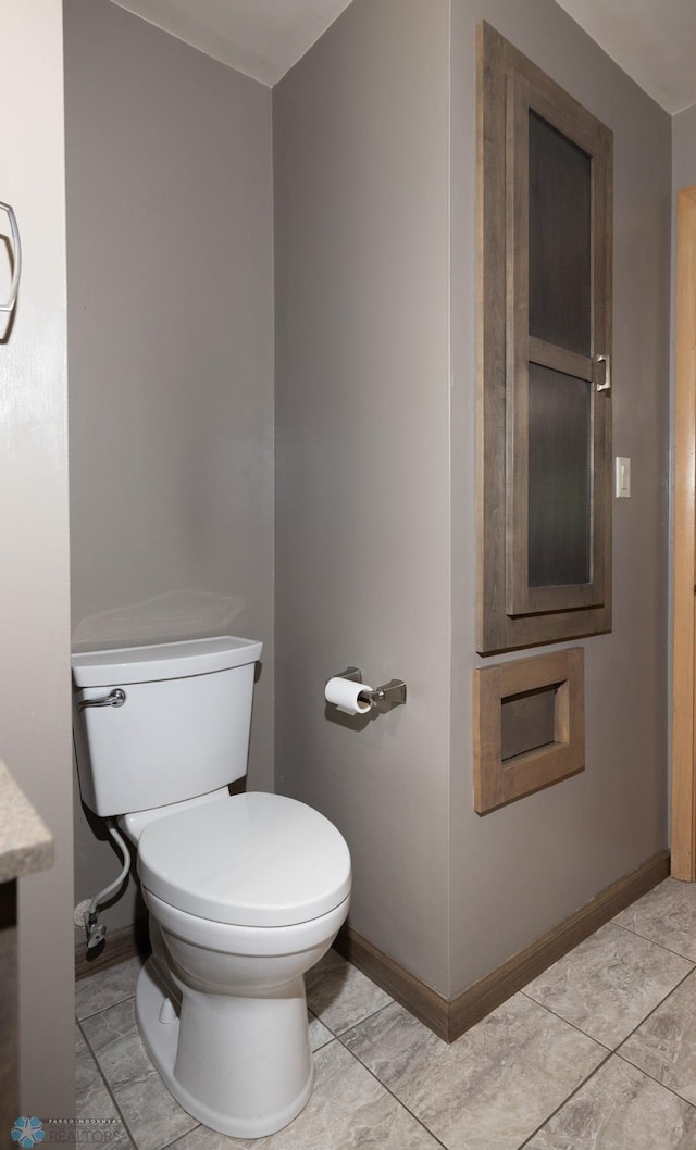 2510 10th St N, Fargo, ND 58102 - bathroom featuring toilet and baseboards