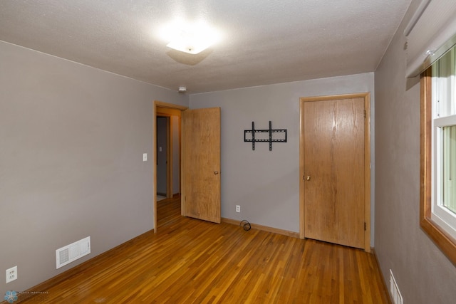 2510 10th St N, Fargo, ND 58102 - unfurnished bedroom featuring wood finished floors and baseboards