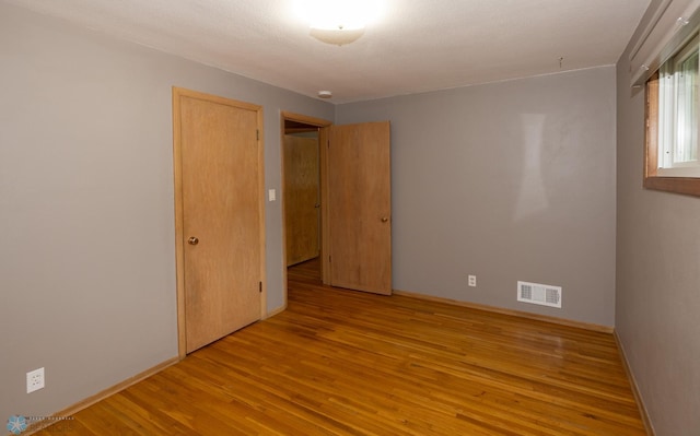 2510 10th St N, Fargo, ND 58102 - empty room with wood finished floors and baseboards