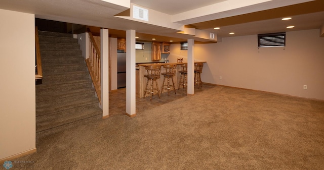 2510 10th St N, Fargo, ND 58102 - finished below grade area featuring freestanding refrigerator, carpet, bar area, stairs, and recessed lighting