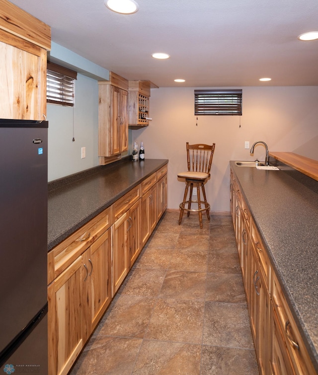 2510 10th St N, Fargo, ND 58102 - kitchen with freestanding refrigerator, dark countertops, dark stone finish flooring, recessed lighting, and open shelves