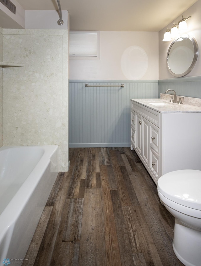 2510 10th St N, Fargo, ND 58102 - bathroom featuring wainscoting, vanity, wood finished floors, and shower / washtub combination