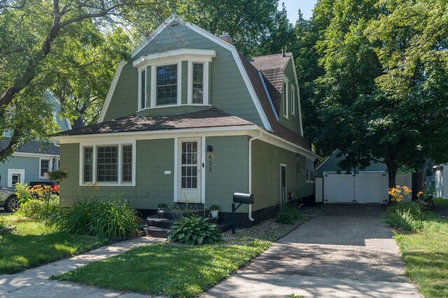 433 S Ave, North Mankato, MN 56003 - colonial inspired home with a gambrel roof, driveway, a shingled roof, a chimney, and an outdoor structure