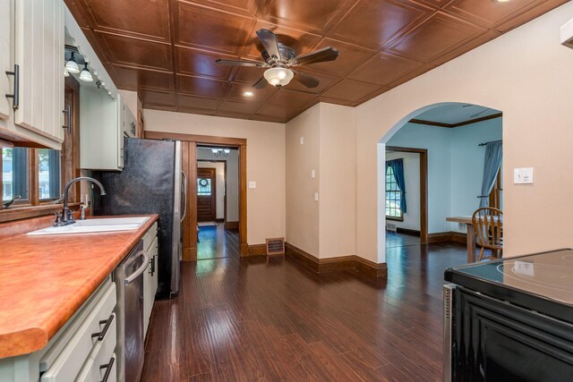 433 S Ave, North Mankato, MN 56003 - kitchen featuring arched walkways, white cabinetry, a ceiling fan, dishwasher, and dark wood-style floors