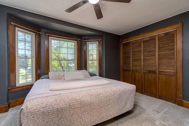 433 S Ave, North Mankato, MN 56003 - bedroom featuring multiple windows, a closet, carpet, a textured ceiling, and ceiling fan