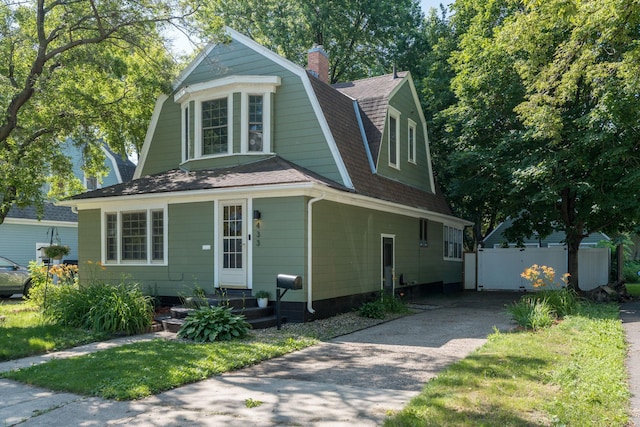 433 S Ave, North Mankato, MN 56003 - dutch colonial featuring a gambrel roof, a shingled roof, a chimney, and driveway