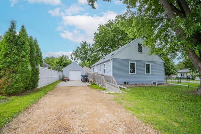 1109 Adams St, Mankato, MN 56001 - view of home's exterior with dirt driveway, a garage, an outdoor structure, and board and batten siding