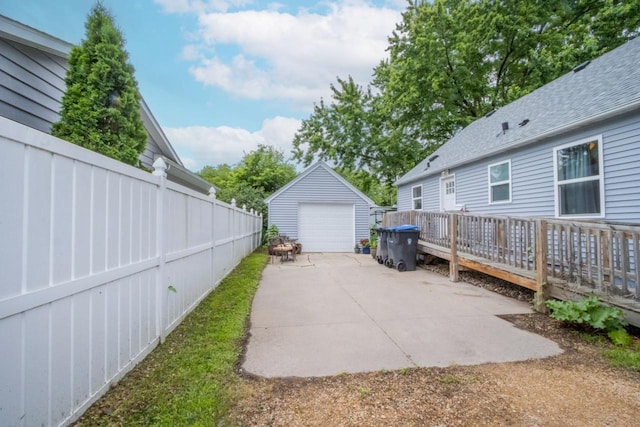 1109 Adams St, Mankato, MN 56001 - view of patio / terrace with a detached garage, an outbuilding, and concrete driveway