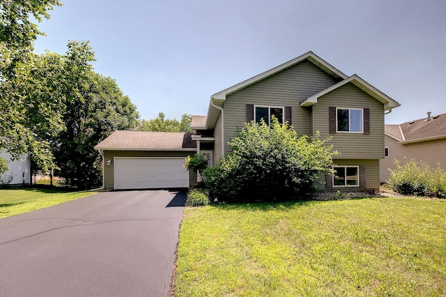775 Leon St, Jordan, MN 55352 - view of front of house featuring a front yard, a garage, and asphalt driveway