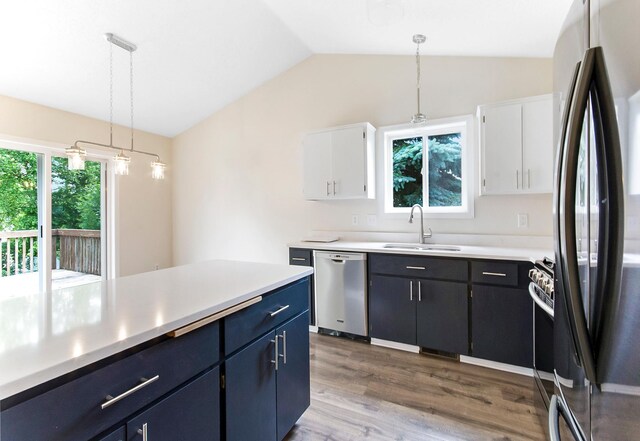 775 Leon St, Jordan, MN 55352 - kitchen with appliances with stainless steel finishes, lofted ceiling, light countertops, pendant lighting, and dark wood-style flooring
