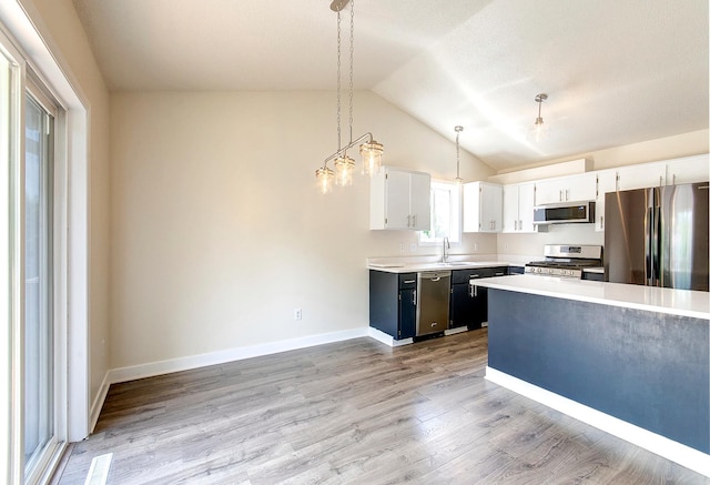 775 Leon St, Jordan, MN 55352 - kitchen with stainless steel appliances, light countertops, lofted ceiling, light wood-type flooring, and white cabinetry