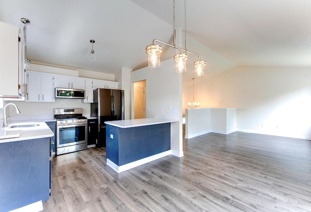 775 Leon St, Jordan, MN 55352 - kitchen featuring stainless steel appliances, vaulted ceiling, light countertops, white cabinets, and light wood finished floors