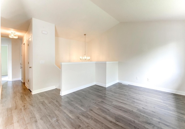 775 Leon St, Jordan, MN 55352 - empty room with a chandelier, wood finished floors, and lofted ceiling