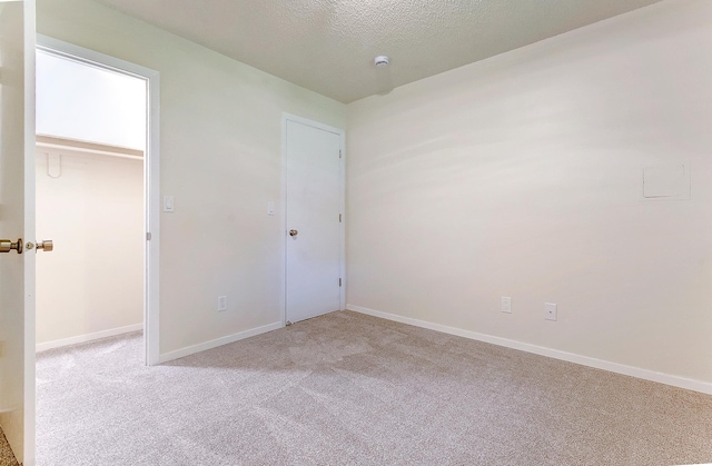 775 Leon St, Jordan, MN 55352 - unfurnished bedroom with carpet floors, a textured ceiling, and a spacious closet