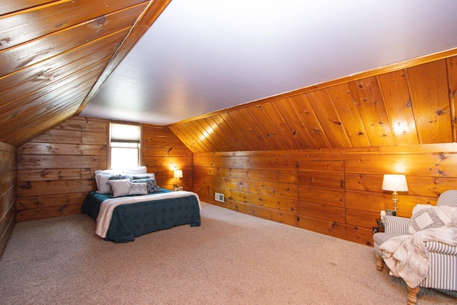 624 Garfield Ave, North Mankato, MN 56003 - carpeted bedroom with wooden walls and vaulted ceiling