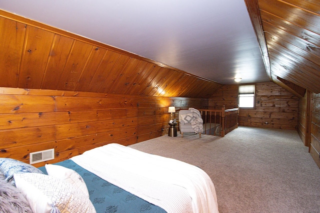 624 Garfield Ave, North Mankato, MN 56003 - carpeted bedroom featuring wood walls and vaulted ceiling
