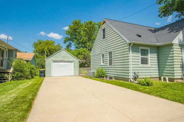 624 Garfield Ave, North Mankato, MN 56003 - view of property exterior featuring a garage, an outbuilding, concrete driveway, a lawn, and roof with shingles