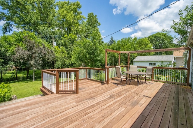 624 Garfield Ave, North Mankato, MN 56003 - wooden deck with outdoor dining area and a lawn