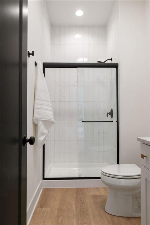 13975 27th St N, West Lakeland Twp, MN 55082 - bathroom with tiled shower, vanity, wood finished floors, and recessed lighting
