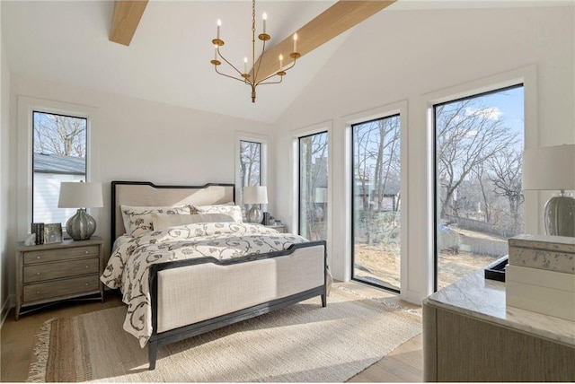 13975 27th St N, West Lakeland Twp, MN 55082 - bedroom with access to exterior, a chandelier, high vaulted ceiling, and wood finished floors