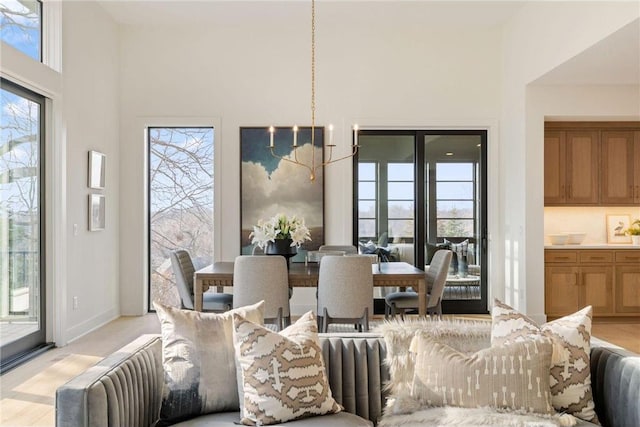 13975 27th St N, West Lakeland Twp, MN 55082 - dining room with plenty of natural light, a towering ceiling, and light colored carpet