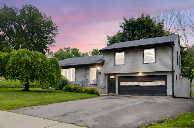 117 Division St, Mankato, MN 56001 - split level home featuring an attached garage, asphalt driveway, and a yard