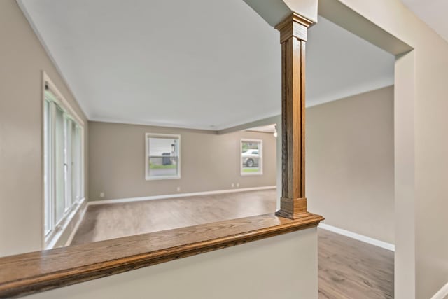 117 Division St, Mankato, MN 56001 - unfurnished living room with light wood-style floors and ornate columns