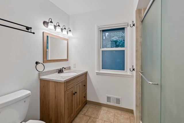 117 Division St, Mankato, MN 56001 - bathroom with vanity, a shower with shower door, and tile patterned floors