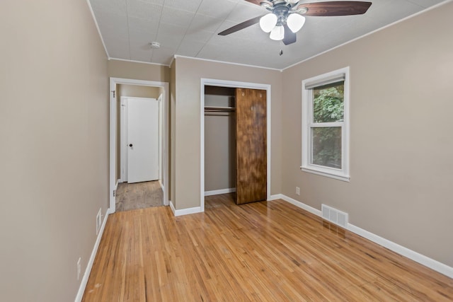 117 Division St, Mankato, MN 56001 - unfurnished bedroom with ornamental molding, light wood-type flooring, a closet, and ceiling fan