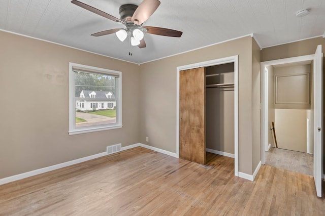 117 Division St, Mankato, MN 56001 - unfurnished bedroom featuring light wood finished floors, a closet, ornamental molding, and ceiling fan