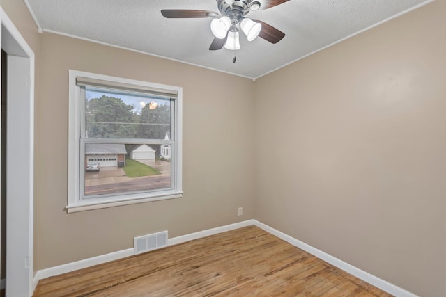 117 Division St, Mankato, MN 56001 - unfurnished room with wood finished floors, ceiling fan, ornamental molding, and a textured ceiling