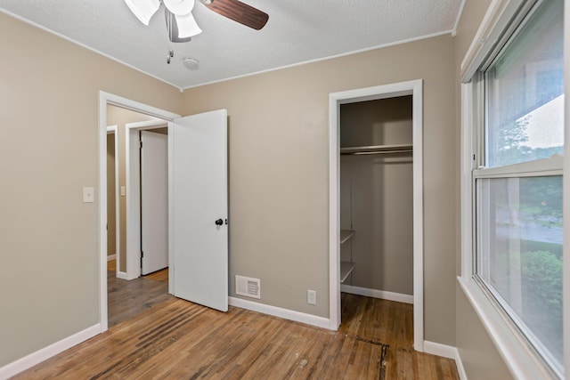 117 Division St, Mankato, MN 56001 - unfurnished bedroom featuring wood finished floors, a closet, a textured ceiling, ornamental molding, and ceiling fan
