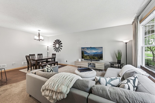 13433 Brick Path, Rosemount, MN 55068 - living room with a chandelier, a textured ceiling, and wood finished floors