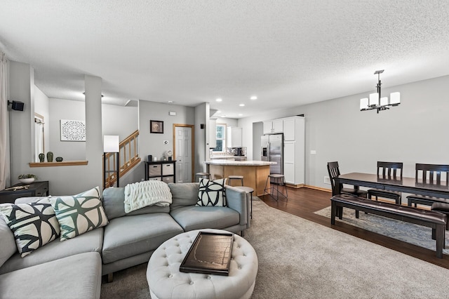 13433 Brick Path, Rosemount, MN 55068 - living room featuring a chandelier, stairway, dark wood-type flooring, recessed lighting, and a textured ceiling