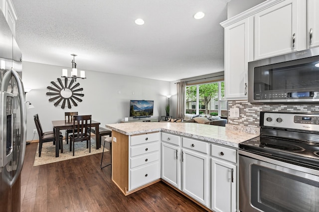 13433 Brick Path, Rosemount, MN 55068 - kitchen with appliances with stainless steel finishes, a peninsula, white cabinetry, tasteful backsplash, and dark wood finished floors