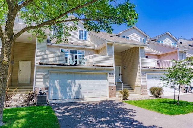7639 Nicholas Way, Chanhassen, MN 55317 - townhome / multi-family property featuring a balcony, driveway, entry steps, and a garage