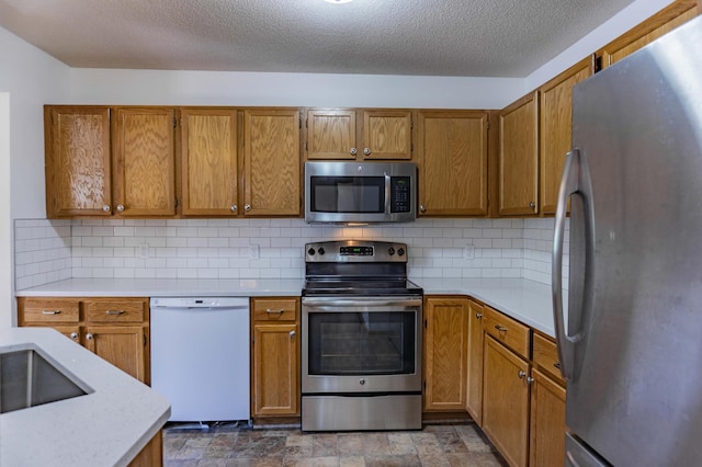 7639 Nicholas Way, Chanhassen, MN 55317 - kitchen with stainless steel appliances, light countertops, brown cabinets, and tasteful backsplash