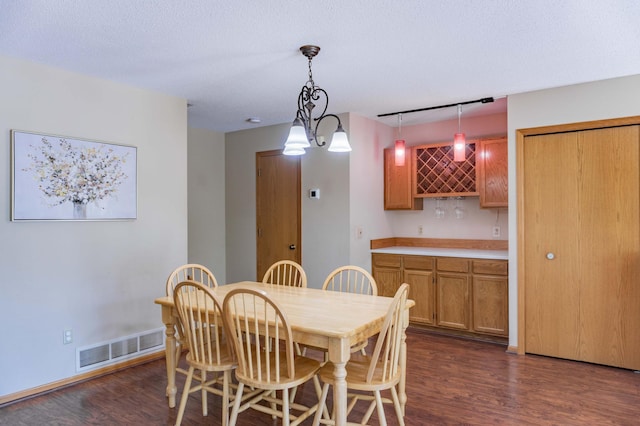 7639 Nicholas Way, Chanhassen, MN 55317 - dining room with bar and dark wood-type flooring